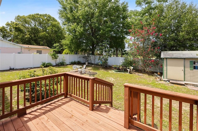 6 Emerald Crse, Ocala, FL 34472 - wooden terrace with a fenced backyard, a storage shed, and a fire pit