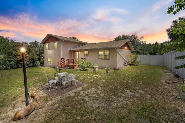6 Emerald Crse, Ocala, FL 34472 - back of house at dusk featuring stucco siding, a gate, a fenced backyard, and a patio