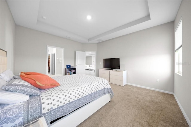 5833 SW 85th Pl, Ocala, FL 34476 - bedroom featuring a tray ceiling, light colored carpet, and connected bathroom