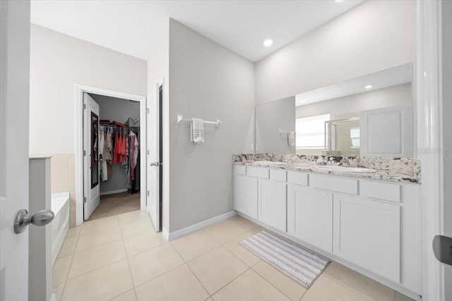 5833 SW 85th Pl, Ocala, FL 34476 - bathroom with a shower stall, a walk in closet, double vanity, a garden tub, and tile patterned floors