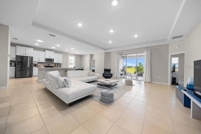 5833 SW 85th Pl, Ocala, FL 34476 - living room featuring a tray ceiling, recessed lighting, and light tile patterned floors