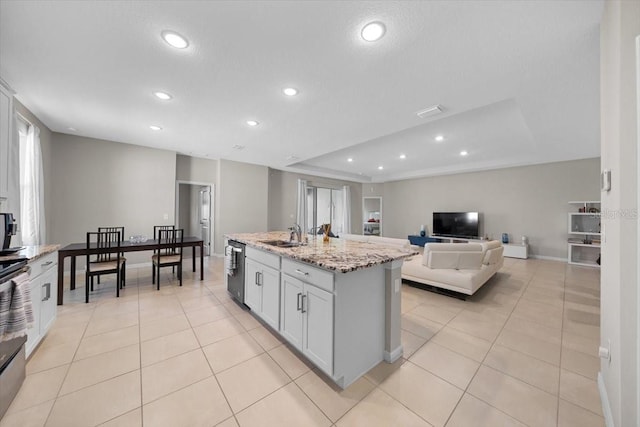 5833 SW 85th Pl, Ocala, FL 34476 - kitchen featuring recessed lighting, light tile patterned flooring, light stone countertops, open floor plan, and dishwasher