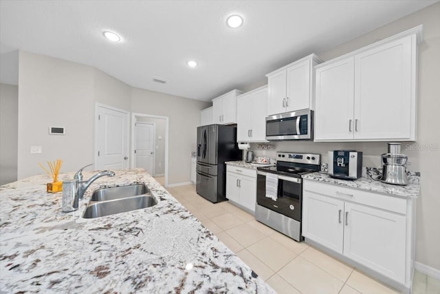 5833 SW 85th Pl, Ocala, FL 34476 - kitchen featuring appliances with stainless steel finishes, white cabinetry, light stone counters, and recessed lighting