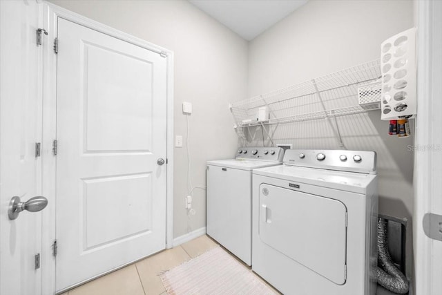 5833 SW 85th Pl, Ocala, FL 34476 - laundry room with washer and clothes dryer and light tile patterned floors