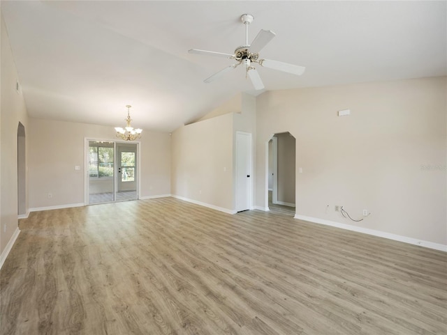 17 Pecan Run Hbr, Ocala, FL 34472 - unfurnished living room with arched walkways, light wood-style floors, a ceiling fan, lofted ceiling, and a chandelier
