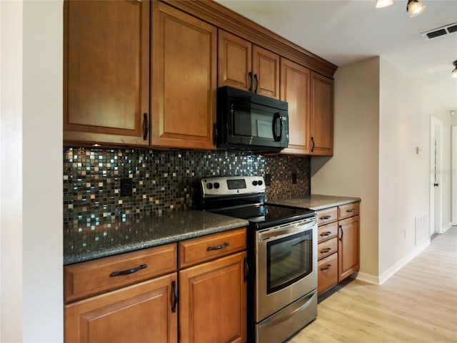 17 Pecan Run Hbr, Ocala, FL 34472 - kitchen featuring black microwave, stainless steel electric range oven, light wood-style flooring, brown cabinets, and decorative backsplash