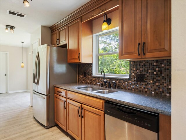 17 Pecan Run Hbr, Ocala, FL 34472 - kitchen with appliances with stainless steel finishes, tasteful backsplash, light wood-style flooring, and brown cabinetry