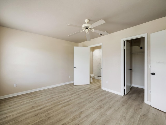 17 Pecan Run Hbr, Ocala, FL 34472 - unfurnished bedroom with light wood finished floors, a walk in closet, a closet, a ceiling fan, and ensuite bathroom