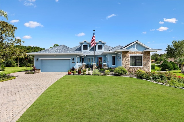 5233 Fountain Walk, Lady Lake, FL 32159 - view of front of property with stucco siding, a front yard, a garage, decorative driveway, and stone siding