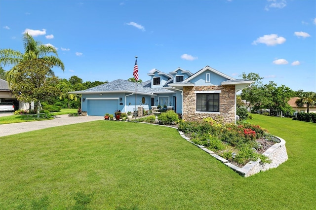 5233 Fountain Walk, Lady Lake, FL 32159 - view of front of property featuring decorative driveway, a garage, a front lawn, stone siding, and stucco siding