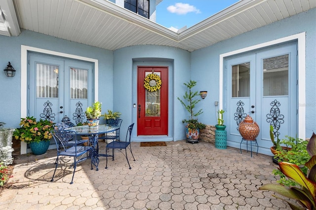 5233 Fountain Walk, Lady Lake, FL 32159 - doorway to property with a patio area, french doors, stucco siding, and outdoor dining area
