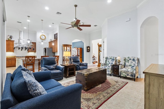 5233 Fountain Walk, Lady Lake, FL 32159 - living area with arched walkways, crown molding, ceiling fan, recessed lighting, and light tile patterned floors