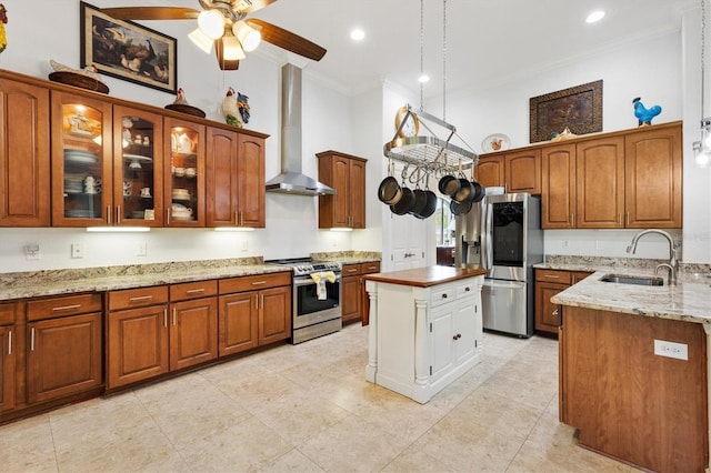 5233 Fountain Walk, Lady Lake, FL 32159 - kitchen featuring appliances with stainless steel finishes, crown molding, wall chimney exhaust hood, ceiling fan, and glass insert cabinets