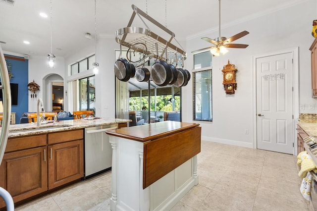 5233 Fountain Walk, Lady Lake, FL 32159 - kitchen with stainless steel dishwasher, crown molding, a ceiling fan, brown cabinetry, and a center island