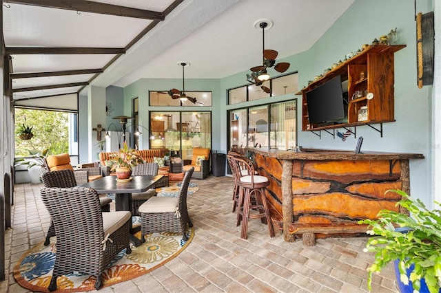 5233 Fountain Walk, Lady Lake, FL 32159 - dining room with ceiling fan, wet bar, brick floors, and beamed ceiling