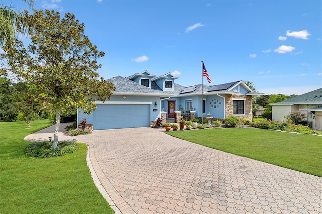 5233 Fountain Walk, Lady Lake, FL 32159 - view of front facade featuring a garage, decorative driveway, a front yard, and roof mounted solar panels