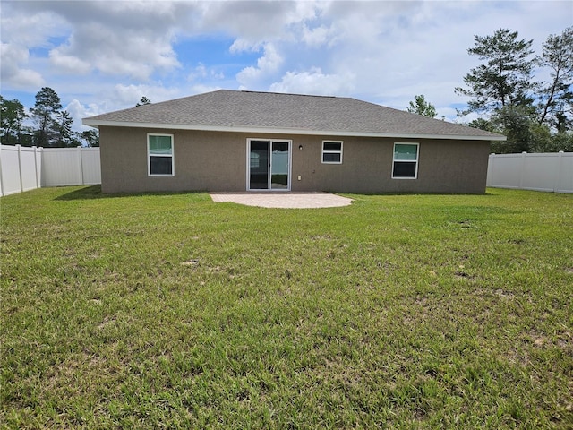 2494 SW 170th Loop, Ocala, FL 34473 - back of property with a patio area, stucco siding, and a fenced backyard