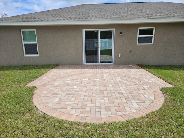 2494 SW 170th Loop, Ocala, FL 34473 - back of house featuring stucco siding, a patio area, a lawn, and a shingled roof