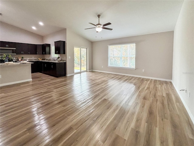 6431 SW 145th Lane Rd, Ocala, FL 34473 - unfurnished living room featuring lofted ceiling, a ceiling fan, and light wood-type flooring