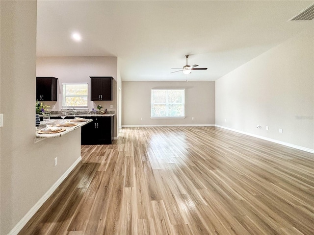 6431 SW 145th Lane Rd, Ocala, FL 34473 - unfurnished living room featuring light wood-type flooring, plenty of natural light, and ceiling fan