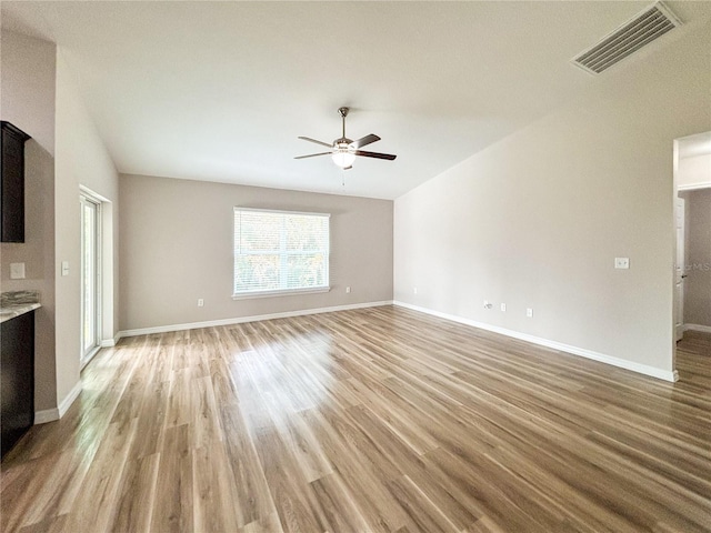 6431 SW 145th Lane Rd, Ocala, FL 34473 - unfurnished living room featuring a ceiling fan, light wood finished floors, and vaulted ceiling