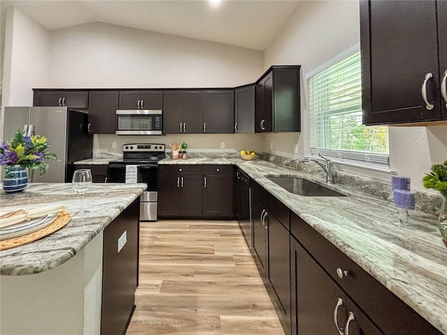 6431 SW 145th Lane Rd, Ocala, FL 34473 - kitchen featuring stainless steel appliances, light wood-style flooring, light stone countertops, dark brown cabinetry, and high vaulted ceiling