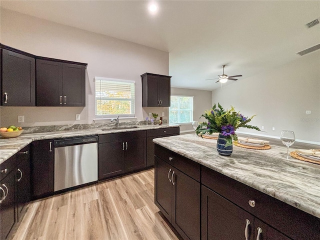 6431 SW 145th Lane Rd, Ocala, FL 34473 - kitchen with stainless steel dishwasher, light wood-type flooring, a ceiling fan, light stone counters, and dark brown cabinetry