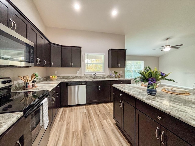 6431 SW 145th Lane Rd, Ocala, FL 34473 - kitchen with appliances with stainless steel finishes, light wood-style flooring, ceiling fan, dark brown cabinets, and light stone counters