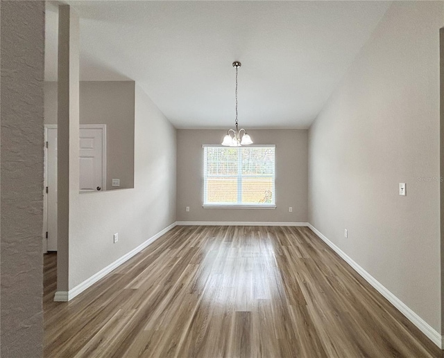 6431 SW 145th Lane Rd, Ocala, FL 34473 - unfurnished dining area featuring wood finished floors, a chandelier, and lofted ceiling
