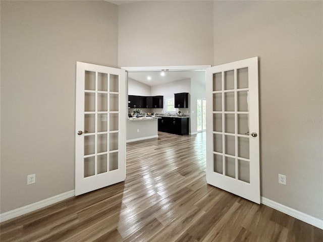 6431 SW 145th Lane Rd, Ocala, FL 34473 - unfurnished room featuring wood finished floors, high vaulted ceiling, and french doors