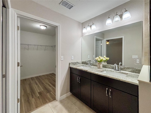 6431 SW 145th Lane Rd, Ocala, FL 34473 - full bathroom with double vanity, ceiling fan, a spacious closet, and tile patterned flooring