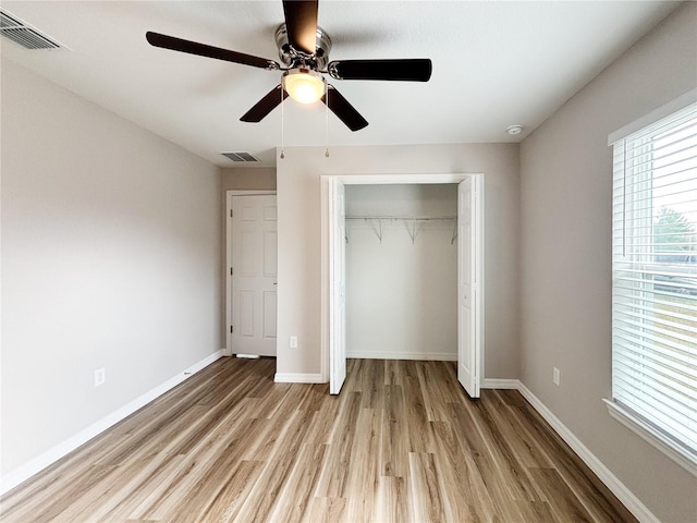 6431 SW 145th Lane Rd, Ocala, FL 34473 - unfurnished bedroom featuring light wood finished floors, a closet, and ceiling fan