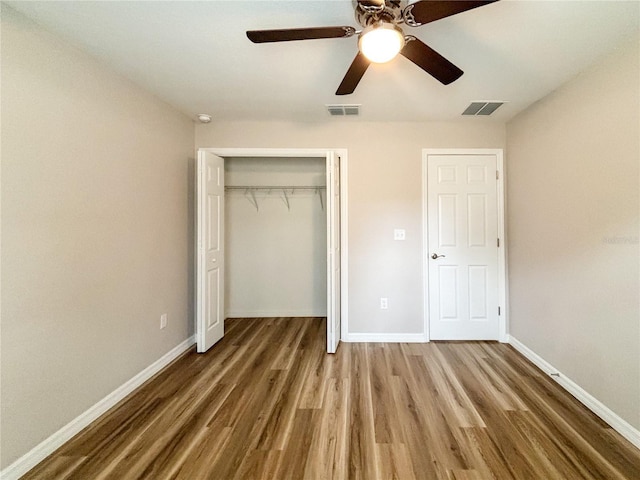 6431 SW 145th Lane Rd, Ocala, FL 34473 - unfurnished bedroom with wood finished floors, a closet, and a ceiling fan