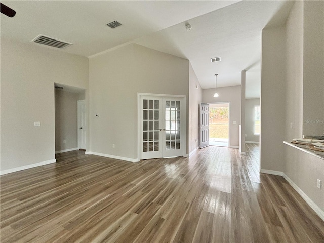6431 SW 145th Lane Rd, Ocala, FL 34473 - unfurnished living room with wood finished floors, french doors, and high vaulted ceiling
