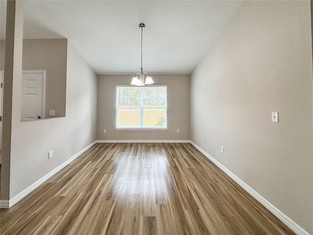 6431 SW 145th Lane Rd, Ocala, FL 34473 - unfurnished dining area with wood finished floors and a chandelier