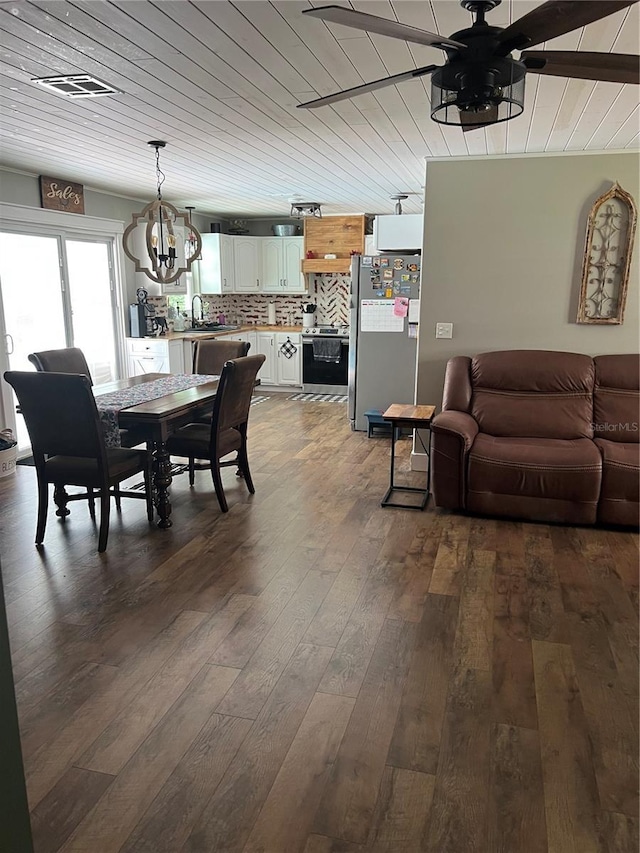 5561 NE 5th Pl, Ocala, FL 34470 - dining area with dark wood-style flooring, a ceiling fan, a chandelier, and wooden ceiling