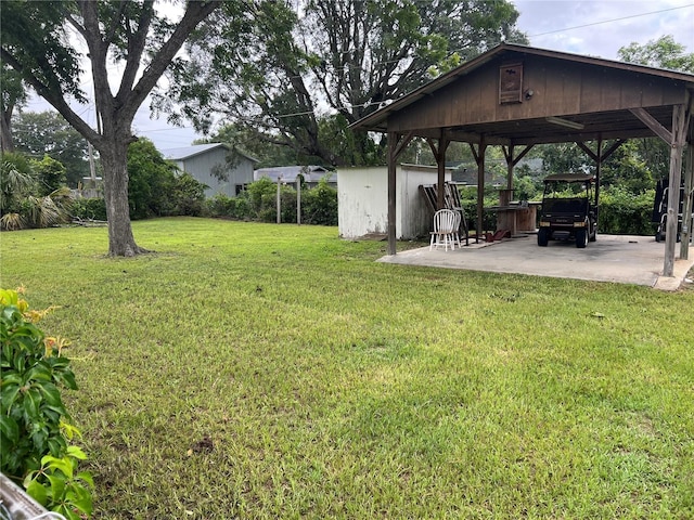 5561 NE 5th Pl, Ocala, FL 34470 - view of green lawn with a carport and a patio area