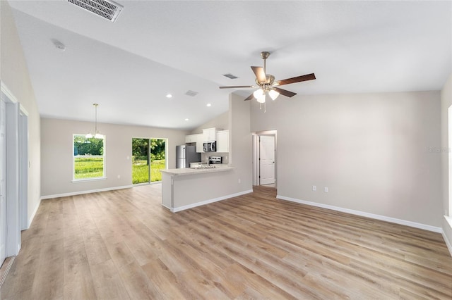 2869 SE 142nd Pl, Summerfield, FL 34491 - unfurnished living room with vaulted ceiling, a ceiling fan, light wood-style floors, and recessed lighting