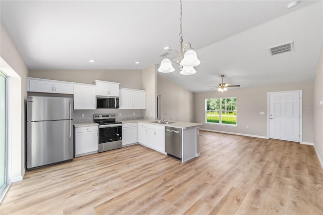 2869 SE 142nd Pl, Summerfield, FL 34491 - kitchen featuring stainless steel appliances, vaulted ceiling, light countertops, a chandelier, and white cabinets