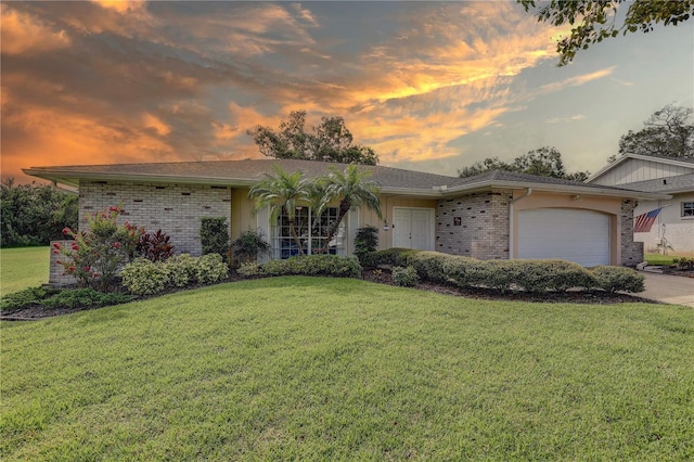 13006 Pebble Beach Cir, Hudson, FL 34667 - ranch-style house with a front yard, a garage, brick siding, and driveway