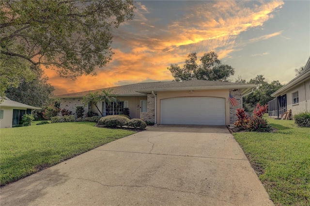 13006 Pebble Beach Cir, Hudson, FL 34667 - view of front of house featuring a front lawn, a garage, driveway, and brick siding