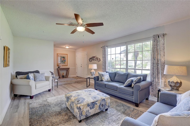 13006 Pebble Beach Cir, Hudson, FL 34667 - living area with ceiling fan, wood finished floors, and a textured ceiling