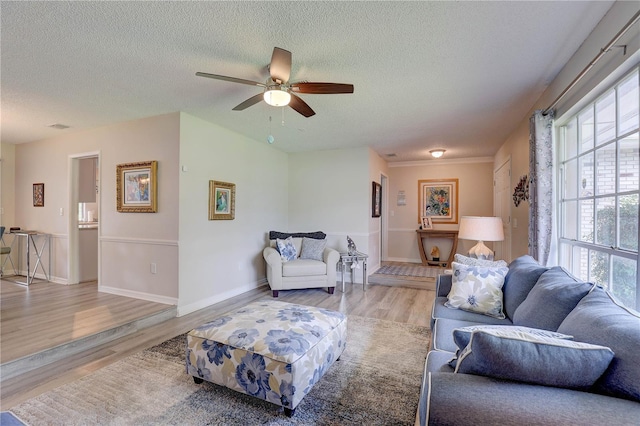 13006 Pebble Beach Cir, Hudson, FL 34667 - living area with wood finished floors, a textured ceiling, and a ceiling fan