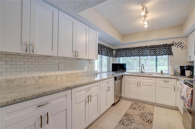 13006 Pebble Beach Cir, Hudson, FL 34667 - kitchen with dishwasher, a textured ceiling, backsplash, white cabinetry, and stove