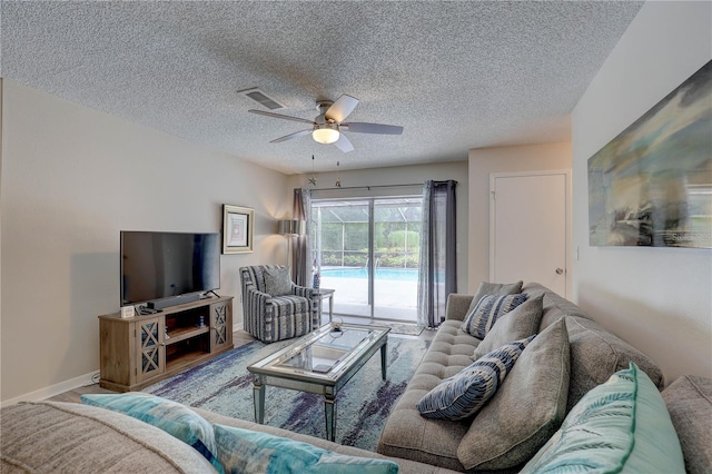 13006 Pebble Beach Cir, Hudson, FL 34667 - living area featuring a ceiling fan and a textured ceiling