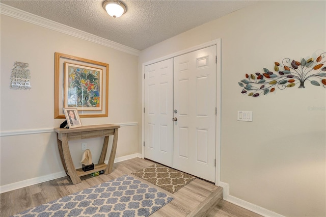 13006 Pebble Beach Cir, Hudson, FL 34667 - entrance foyer featuring light wood-style floors, a textured ceiling, and crown molding