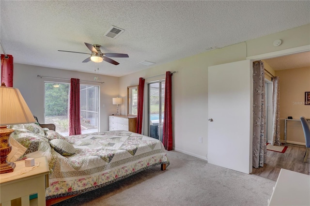 13006 Pebble Beach Cir, Hudson, FL 34667 - bedroom featuring a textured ceiling, a ceiling fan, and carpet floors