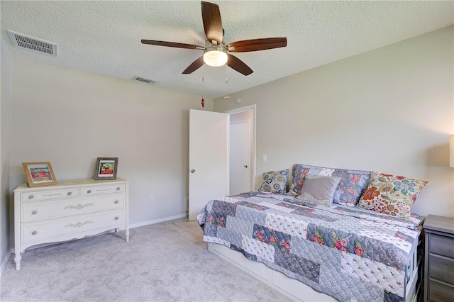 13006 Pebble Beach Cir, Hudson, FL 34667 - carpeted bedroom with a textured ceiling and ceiling fan