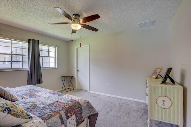 13006 Pebble Beach Cir, Hudson, FL 34667 - bedroom with a textured ceiling, light colored carpet, and a ceiling fan