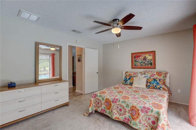 13006 Pebble Beach Cir, Hudson, FL 34667 - bedroom featuring light colored carpet, a textured ceiling, and a ceiling fan